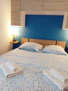a bedroom with a bed with two towels on it at Chez Pierre in Narbonne