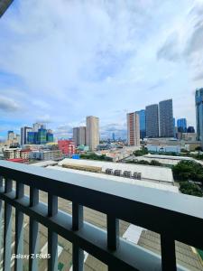 a view of a city skyline from a balcony at Affordable Condotel near Sm Megamall with Fast WiFi in Sampong +64 photos