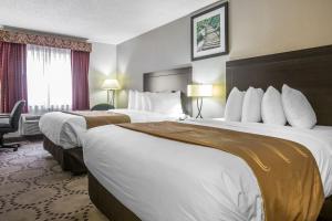 a hotel room with two beds and a window at Quality Inn Stockbridge Atlanta South in Stockbridge +23 photos