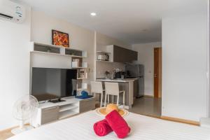 a room with a bed with red towels on it at 1 BR Suite 8-198 at Ozone Condo near Kata beach and surf in Kata Beach