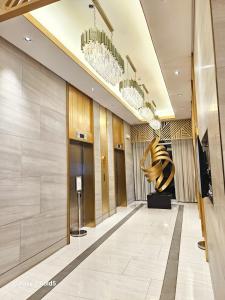 a lobby of a hotel with a large sculpture at Affordable Condotel near Sm Megamall with Fast WiFi in Sampong