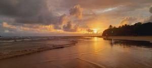 a sunset on a beach with the ocean at Serene Villa in Beruwala