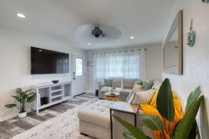 Una sala de estar con un sofá y un televisor. en Tropical Vibes Bungalow w Pool, en Ormond-by-the-Sea