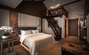 a bedroom with a large bed and a staircase at Liu Ruju Song's Courtyard in Lijiang