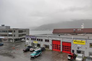 a group of buildings with cars parked in a parking lot at Centrally located apartment in Tromsø in Tromsø