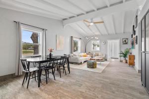 a dining room and living room with a table and chairs at 172 Woodland Ave in Cocoa Beach