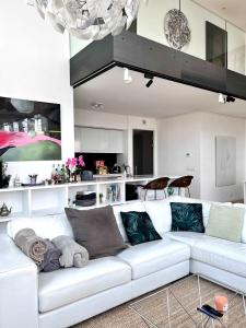 a white couch in a living room with a kitchen at Skyline Penthouse Brussels 220 m2 of Pure Luxury Suite in Brussels