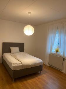 a bedroom with a bed and a window at Entire 4 rooms Cozy apartment in central Älmhult in Älmhult