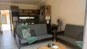 a living room with two chairs and a table at MiCasa 62 in Potchefstroom