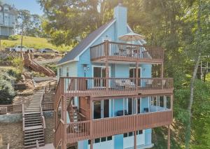 a house with balconies on the side of it at Lakefront Escape with Sauna Hot Tub BBQ & Games in Norris Lake Shores
