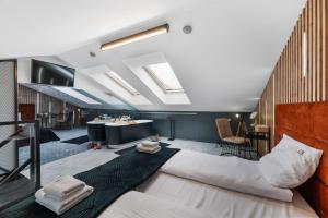 a hotel room with a large bed in the middle at Calm Sauna & Jacuzzi by OneApartments in Sopot