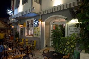 a restaurant with tables and chairs in front of a building at Luna Hotel Kaleiçi in Antalya