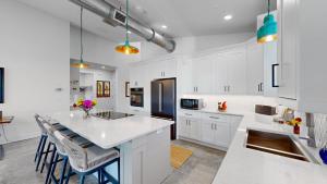 a kitchen with white cabinets and a kitchen island with stools at 409 Washington Ave in Cape Canaveral