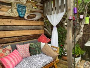 a couch with colorful pillows on a patio at Eden's Studio in Sellicks Beach