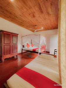 a bedroom with two beds and a wooden ceiling at Sun Shine Inn Unawatuna in Galle +62 photos