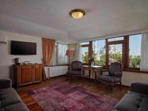 ein Wohnzimmer mit Tisch und Stühlen und einem Fernseher in der Unterkunft 1207 Hotel Special Class Sultanahmet in Istanbul
