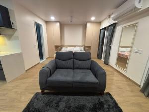 a living room with a couch and a bedroom at Aura Living in Pune