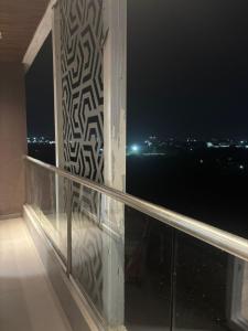 a balcony with a view of the ocean at night at Aura Living in Pune
