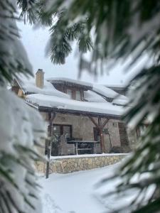 a house with snow on the roof at Vikendica ''CASA DE TARA'' - Planina Tara in Kaludjerske Bare