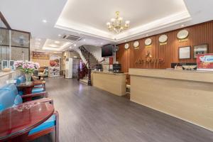 a restaurant with a counter and tables and chairs at A25 Hotel - 61 Lương Ngọc Quyến in Hanoi