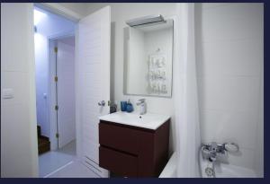 a white bathroom with a sink and a mirror at Relax Blue Marlin Pasito Blanco in Pasito Blanco +22 photos