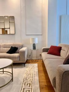 a living room with two couches and a table at Spacious Family Apartment for 9 near Brussels Midi Station in Brussels