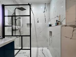 a white bathroom with a shower and a sink at Spacious Family Apartment for 9 near Brussels Midi Station in Brussels