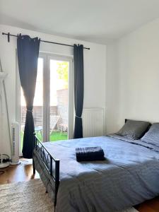 a bedroom with a bed and a sliding glass door at Spacious Family Apartment for 9 near Brussels Midi Station in Brussels