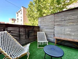 a patio with two chairs and a table and a bench at Spacious Family Apartment for 9 near Brussels Midi Station in Brussels