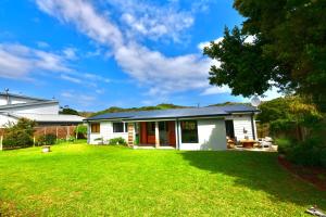 a house with a green lawn in front of it at Bobinga Peksan in Sedgefield