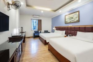 a hotel room with two beds and a television at A25 Hotel - 61 Lương Ngọc Quyến in Hanoi