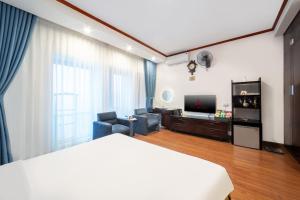 a hotel room with a bed and a living room at A25 Hotel - 61 Lương Ngọc Quyến in Hanoi
