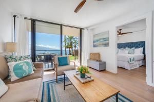 a living room with a couch and a bed at Lauloa 105 · LOA 105 2BD OceanFront Getaway w AC Pool in Wailuku +54 photos
