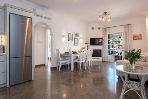 a kitchen and living room with a table and chairs at Kassiopi Home in Kassiopi