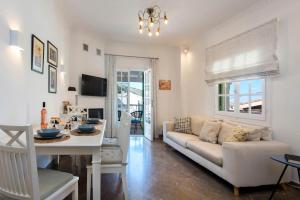 a living room with a couch and a table at Kassiopi Home in Kassiopi