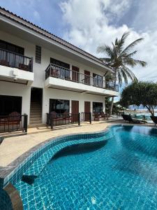 a swimming pool in front of a house at Mr. Black Resort in Haad Rin