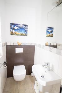 a bathroom with a white toilet and a sink at Marina 24-A in Cuxhaven +37 photos