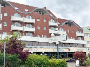 a large red brick building with a sign in front of it at Deichgraf 345 in Döse
