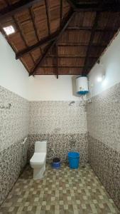 a bathroom with a toilet in a room at The Nest bettathur, Coorg in Madikeri