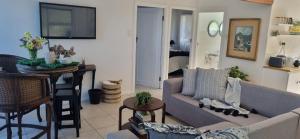 a living room with a couch and a table at Dinky's Place in Herolds Bay