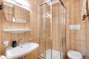 a bathroom with a shower and a sink and a toilet at Veltierhof Villnöß in Funes +90 photos