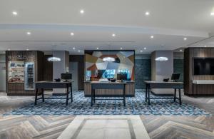 a lobby of a hotel with two desks at NYX Hotel Erfurt by Leonardo Hotels in Erfurt