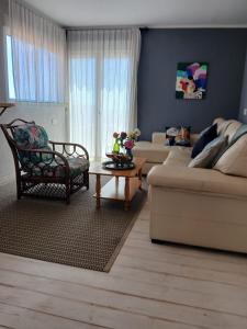 a living room with a couch and a table at El jardin de Valle de Guimar in Güimar +12 photos
