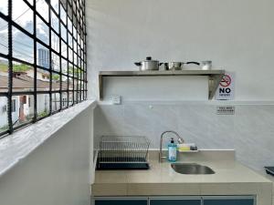 a kitchen with a sink and a window at Comfort Homestay JB Town near CIQ in Johor Bahru +74 photos