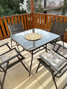 a blue table and two chairs on a deck at Dom gościnny Ania, Apartament nr 7 in Wisełka