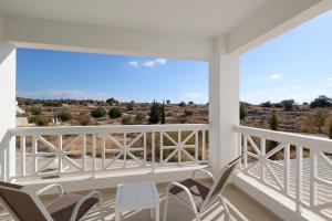 a balcony with chairs and a view of the desert at Perdika Residences in Perdika