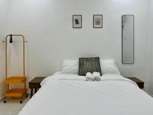 a bedroom with a bed with two shoes on it at Comfort Homestay JB Town near CIQ in Johor Bahru
