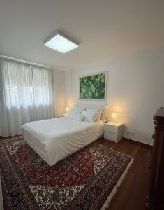 a bedroom with a white bed and a rug at Tenuta Vinci in Capannori +9 photos