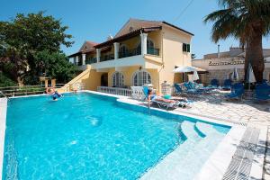 a house with a swimming pool in front of a house at Kassiopi Home in Kassiopi