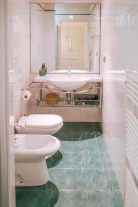 Un baño blanco con lavabo e inodoro. en SM Hospitality MONTE PASUBIO, en Reggio Emilia